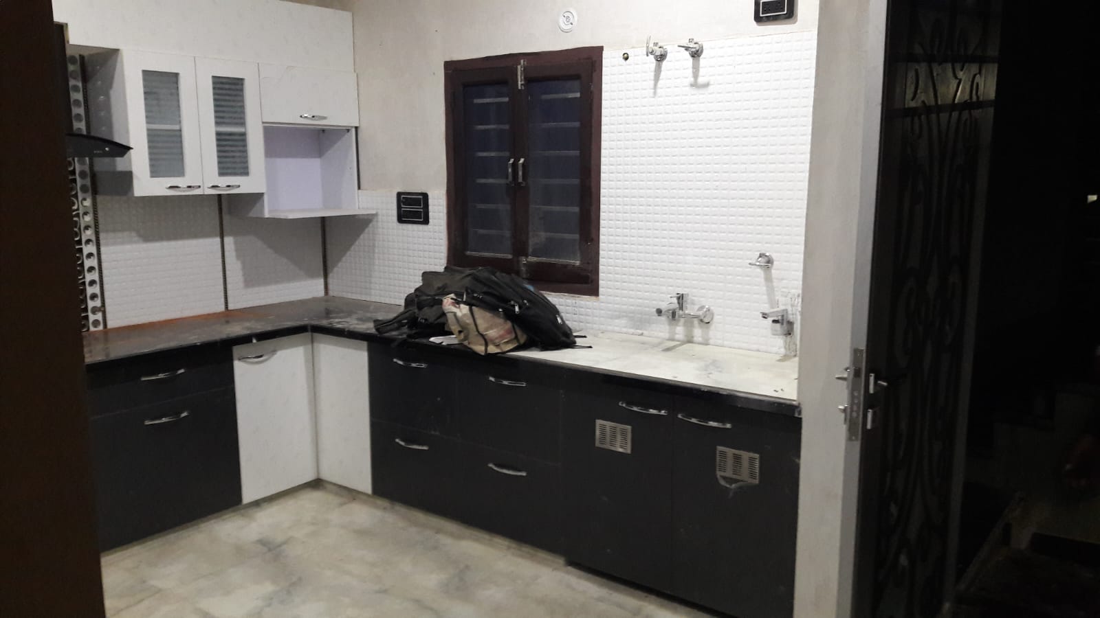 Monochrome L-shaped modular kitchen utility view Bharatpur